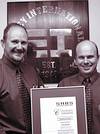 Andrew Stead (managing director) and Stephen Martinussen (quality manager) proudly holding Elvey&#8217;s ISO certificate